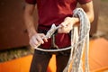 A rock climber tie a knot on a rope. A person is preparing for the ascent. Man learns to tie a knot near climbing wall Royalty Free Stock Photo