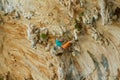 Rock climber on tufas climbing route in Kalymnos, Greece