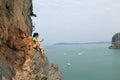 Rock climber use smartphone at seaside mountain cliff Royalty Free Stock Photo