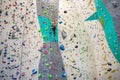 Rock climber young woman hanging on colored hooks on climbing artificial wall indoors of sport centre of Prague. Extreme Royalty Free Stock Photo