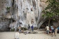 Rock climbers climbing the wall on Phra Nang beach