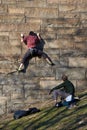 Rock climbers practicing their skills on the stonework of an entry ramp to the Brooklyn Bridge