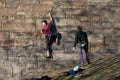 Rock climbers practicing their skills on the stonework of an entry ramp to the Brooklyn Bridge