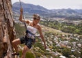 Rock climbing, fitness and woman on a mountain for wellness, freedom or training outdoor. Mountain, cliff or female Royalty Free Stock Photo