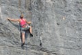 Rock Climbing Girl on rock face in red top