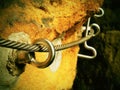 Rock climbing safety path via ferrata. Steel chrome anchores in rock hold steel twisted rope