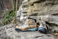 rock climbing shoes next to chalk bag on cliff