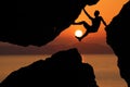Silhouette man Climbing between rocks with red sky sunset background Royalty Free Stock Photo