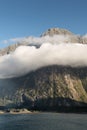 Rock and cloudscape in Milford Sound, New Zealand. Royalty Free Stock Photo