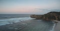 Rock coast at sand beach washed by ocean bay waves aerial view. Nobody tropical Indonesia landscape Royalty Free Stock Photo