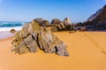 Rock on coastline of sandy Adraga beach, Portugal coast Royalty Free Stock Photo