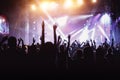 Rock concert, cheering crowd in front of bright colorful stage lights Royalty Free Stock Photo