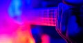 Rock concert. Guitarist plays on the illuminated lamps guitar. Hand close up