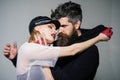 Rock couple embrace on grey background. couple in love of woman and bearded man. hipster with beard and girl in