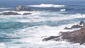 Rock crag of cliff, ocean beach, Point Lobos, California coast. Waves crashing.