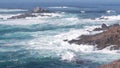 Rock crag of cliff, ocean beach, Point Lobos, California coast. Waves crashing.