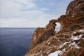 The Rock of Desires or Wish window near Aya Bay. Lake Baikal at the beginning of winter on a cloudy December day Royalty Free Stock Photo