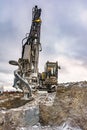 Rock drilling machine to make hole and build a building Royalty Free Stock Photo