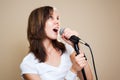 Rock female vocalist on gray background Royalty Free Stock Photo