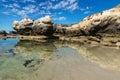 Rock formation with cliff with reflections in the sea at Peterborough beach, Victoria, Australia Royalty Free Stock Photo