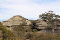 Overhanging Rock Formation and Gum Trees
