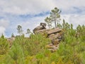 Rock formation surrounded by pine trees in the mountains of Geres Royalty Free Stock Photo
