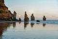 Rock formations on the beach known as Three Sisters and the Mount Taranaki behind. New Plymouth, New Zealand Royalty Free Stock Photo