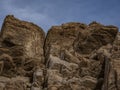 Palm Desert Rock Outcrops with a long fissure against a blue sky Royalty Free Stock Photo