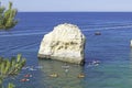 Rock formations and people doing kayaks in the Atlantic ocean to visit the Benagil caves, Algarve, Portugal