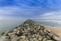 Rock groin jutting out into the Pacific Ocean - California