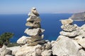 Rock stones cairn, poise light pebbles on rock with blue natural ocean natural background, zen like, harmony and balance Royalty Free Stock Photo