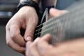 Rock guitarist fingers on guitar strings Royalty Free Stock Photo