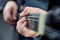 Rock guitarist fingers playing on guitar strings Royalty Free Stock Photo