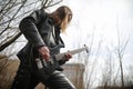 Rock guitarist on the steps. A musician with a bass guitar in a Royalty Free Stock Photo