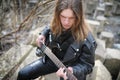 Rock guitarist on the steps. A musician with a bass guitar in a Royalty Free Stock Photo