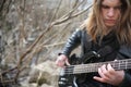 Rock guitarist on the steps. A musician with a bass guitar in a Royalty Free Stock Photo