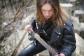 Rock guitarist on the steps. A musician with a bass guitar in a Royalty Free Stock Photo