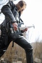 Rock guitarist on the steps. A musician with a bass guitar in a Royalty Free Stock Photo