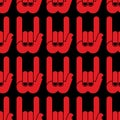 Rock hand sign seamless pattern. Black background and red hands. Royalty Free Stock Photo