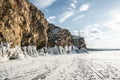 Rock on the ice of winter Baikal on Olkhon island in Siberia. Beautiful nature: mountains, frozen lake, blue sky Royalty Free Stock Photo