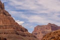 Rock layers of Grand Canyon under a cloudy blue sky Royalty Free Stock Photo