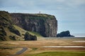 Rock, lighthouse and sea arch at Dyrholaey, Iceland Royalty Free Stock Photo