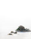 A rock among the mist of the sea and clouds Royalty Free Stock Photo