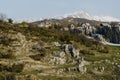 Rock mountain with the background of snowy peak