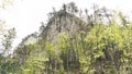 Rock mountain cliff and blue sky. Photo of Huge Rock Mountains Surrounded by Green Trees. Epic Mountain Landscape Royalty Free Stock Photo