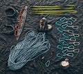 Rock or mountain climbing equipment or tools against dark background with a carabiner hook, rope for safety and security