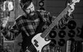 Rock musician concept. Musician, frontman, soloist, singer play guitar in music club on background. Man on shouting face Royalty Free Stock Photo