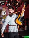 Rock musician concept. Talented musician, soloist, singer play guitar in music club on background. Man on shouting face Royalty Free Stock Photo