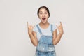 Rock n roll. Funny spanish woman in denim overalls, looking at c Royalty Free Stock Photo