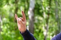 Rock `n roll hand sign. Gesture mens hand of three fingers. Concept of positive, Rock and Roll, win, devil horns. Closeup view on Royalty Free Stock Photo